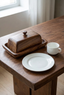 Contenedor Eira Madera sólida en mesa con plato y taza para referencia de tamaño
